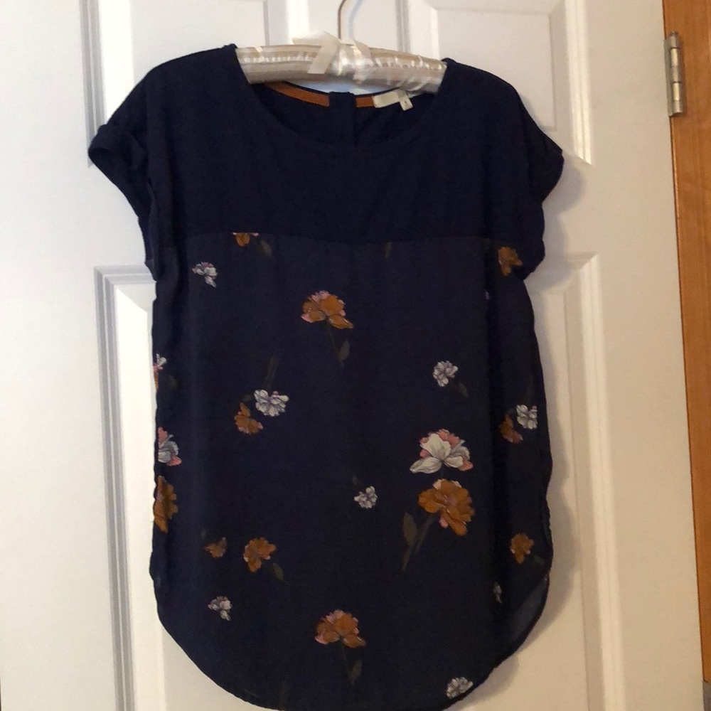 Navy blue floral shirt with buttons on back.